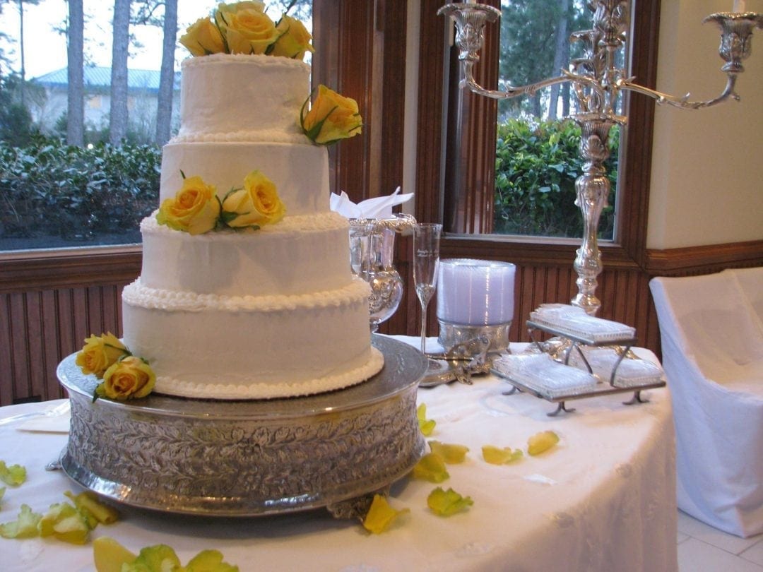 white wedding cake with yellow roses